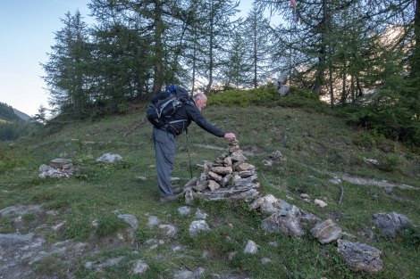 Dad placing a stone on a cairn, hopefully he's asking for good weather for the hike!