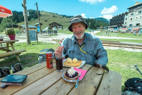 Dad about to tuck into a waffle at Col de Voza (1653m) with the Tramway du Mont Blanc line behind him