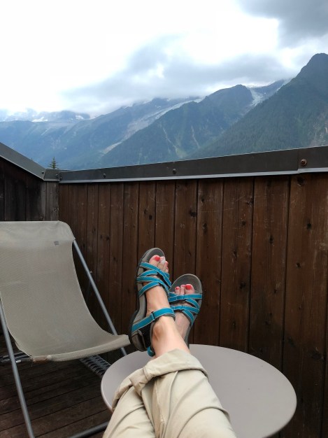 Relaxing on our balcony with a view of Mont Blanc (obscured by cloud in this photo) at Hotel Les Campanules