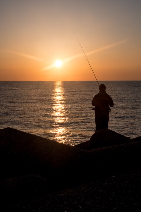 A fisherman at sunrise at Cape Rokko, Noto Peninsula