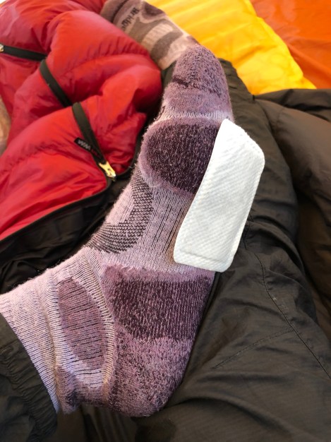 It's really cold at night and I made a BIG mistake bringing my summer sleeping bag! These are hand warmers I've taped under my feet!