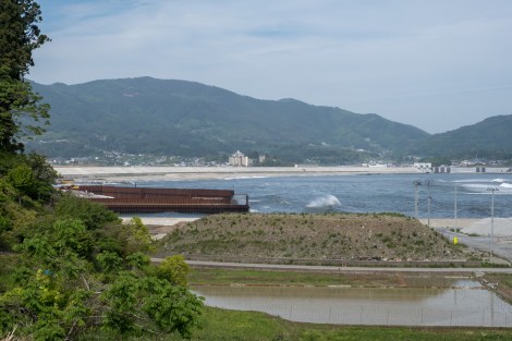 Building a giant wall along the coastline that was affected in the 2011 tsunami