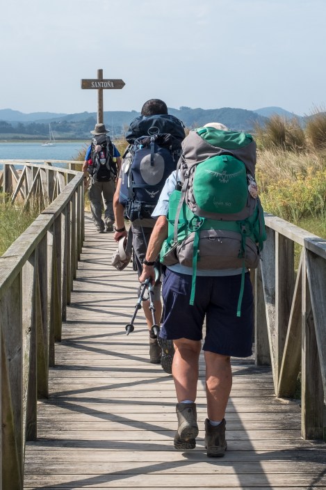 Pilgrims heading down the boardwalk to the boat across to Santoña