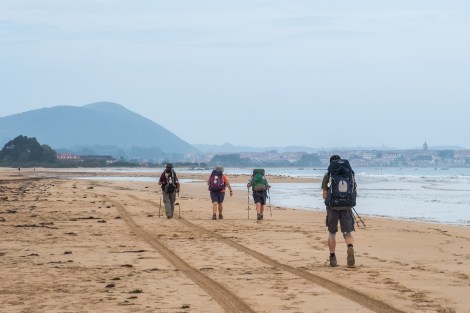 Pilgrims walking along Playa de Noja towards Noja