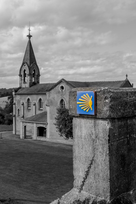 A Camino waymark and the Church of St Saviour (Parroquia de San Salvador) in Piñera