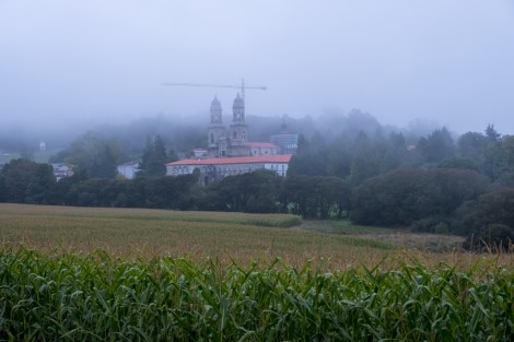 A misty morning view looking back at Monasterio de Sobrado